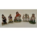A collection of five 19th Century Staffordshire figures including; bacchanalia figure; shoemender;