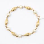 A pearl and 9ct gold fancy-link bracelet, with alternate pearl and torpedo shaped gold links, length