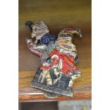 A pair of German Punch and Judy cold painted cast door knockers (2)