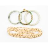 **REOFFER IN A&C NOV £40-£50** Three jade type bangles comprising white and green versions, one with