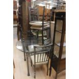 ***AWAY***A modern metal frame patio dining suite, four chairs and one circular glass top table. (