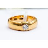 A gents diamond set 18ct gold ring, flush set old cut diamond  to the top, approx. 0.20ct,  size