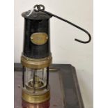 A GPO marked Miners Lamp. Black painted body with brass fittings.