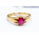 A synthetic ruby and 18ct gold gents ring, round cut stone claw set stone measuring approx. 6mm,