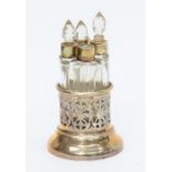 Four scent bottles in a scent stand, Birmingham 1924 Levi & Salaman (one stopper lost)