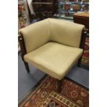 An early 20th century Victorian style leather upholstered corner chair on turned supports.