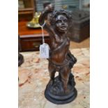 A French 19th Century bronze putto statue holding grapes, 29cms high approx, not signed