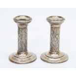 A pair of weighted Silver candlesticks