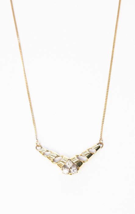A diamond and 9ct gold pendant, the twisted shaped set with three claw set diamonds, to fine link
