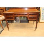 Early Victorian desk on turned flute supports with brass castors.