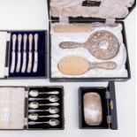 A boxed white metal back mirror and brush set; a set of six boxed spoons, Sheffield 1946; silver