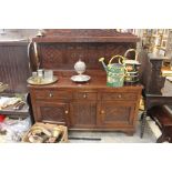 A 17th Century style carved oak sideboard.