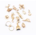 Thirteen assorted charms, to include 9ct gold versions such as a ballerina, boot, scorpion etc