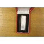 A Cartier white metal lighter, ribbed, boxed