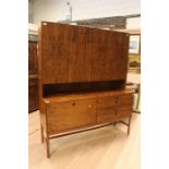 A mid century walnut veneered sideboard. The lower section consisting of four smaller drawers and