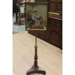 An early Victorian tapestry framed polescreen circa 1860, a brass pole supporting an oak frame