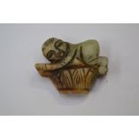 **REOFFER IN A&C NOV £20-£30** A jade figure of a man on basket