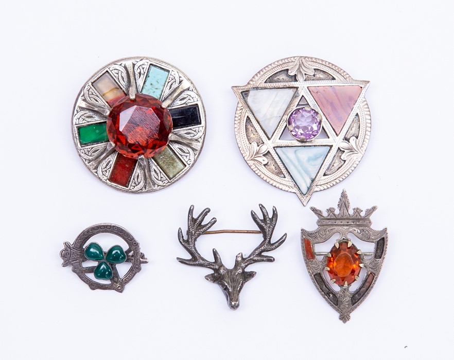 A collection of  brooches to include a silver stags head, William Henry Leather Birmingham 1919,