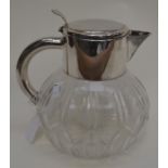 A Mappin & Webb silver plated water jug with interior glass sleeve for ice, cut glass base