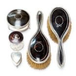 A collection of early 20th Century tortoiseshell and silver mounted dressing table items including a