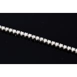 A diamond and 18ct white gold tennis bracelet, comprising forty-four round brilliant cut diamonds,