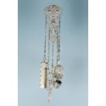 An Edwardian silver Chatelaine, ornate top section with central female medallion above scrolling