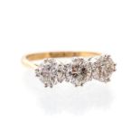 A diamond three stone 18ct gold ring, comprising three round  brilliant cut diamonds with a total