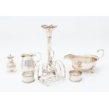 A collection of silver tableware including: a George VI oval sauceboat, on three hoof and shell