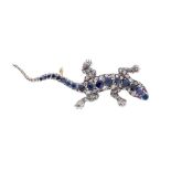 A blue spinel and diamond brooch in the form of a lizard, round cut blue stones set to the spine