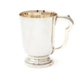 An Elizabeth II plain tapering cylindrical mug, shaped handle on stepped base, by G Bryan & Co,