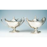 A pair of George III silver sauce tureens and covers, boat shaped on oval feet with loop handles,