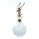 An Elizabeth II silver mounted glass liquer decanter, the silver detachable stopper cast as a Stag's