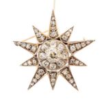 A late Victorian diamond set star pendant/brooch, the central off round old cut diamond weighing