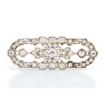 An Art Deco diamond and white sapphire brooch, open geometric form set to the centre with an old cut