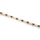 A sapphire and diamond cluster line bracelet, comprising eleven oval sapphire and diamond cluster