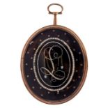 An 18th century large gold framed oval mourning pendant, enclosing blue enamel set with seed