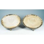 A matched pair of George III silver salvers, beaded rim above three shell and scroll feet, the