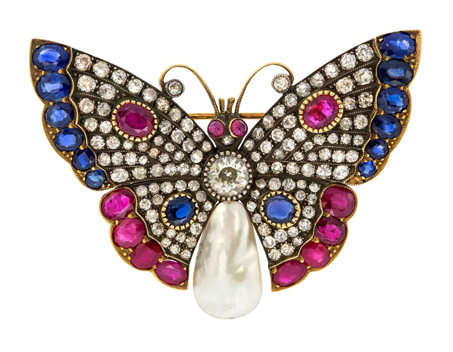 An Edwardian diamond, ruby, sapphire and blister pearl butterfly brooch, the central round old cut