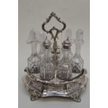 A Victorian silver-plate cruet stand, the body shaped oval chased with floral panels  on scroll