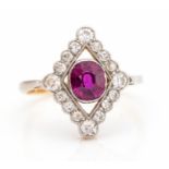 An Art Deco ruby and diamond north-south cocktail ring, the centrally set cushion-cut ruby approx