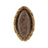 An 18th/19th century navette shaped gilt metal and enamel mourning brooch, set with a plait of hair,