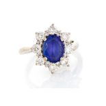 A tanzanite and diamond oval cluster 18ct white gold ring, the oval mixed-cut tanzanite approx 9mm x