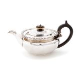 A George III (Regency) silver melon shaped teapot, plain body with gadroon border, C-scroll