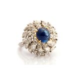 A sapphire and diamond ring, the cabachon cut blue  sapphire weighing approx 3 carats, claw set