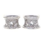 A pair of Victorian silver circular salt dish rings in the Irish manner, the concave bodies chased