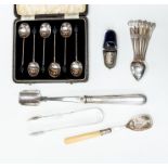 A collection of silver including: an Edwardian stilton scoop, Sheffield, 1902; a jam spoon with