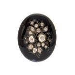 A 19th century diamond and black enamel oval brooch/pendant, stylised spray of oval, pear-shaped and