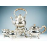 An early 20th Century Irish Celtic Revival matched four piece tea service, including tea kettle on