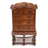 A Queen Anne style mahogany miniature chest on stand, triple arched pediment over two short and