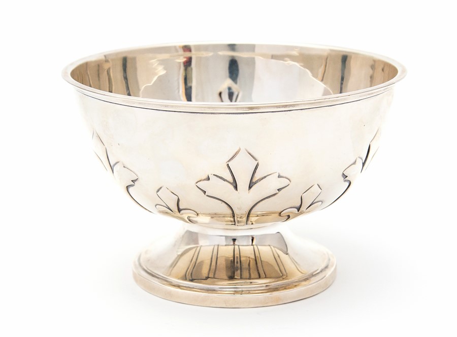 An Arts & Crafts silver circular rose bowl, plain body chased with stylised trefoil strapwork